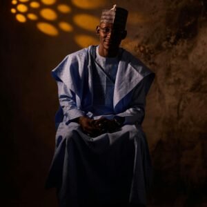 Captivating portrait of a man wearing traditional Nigerian clothing, set against a textured background.