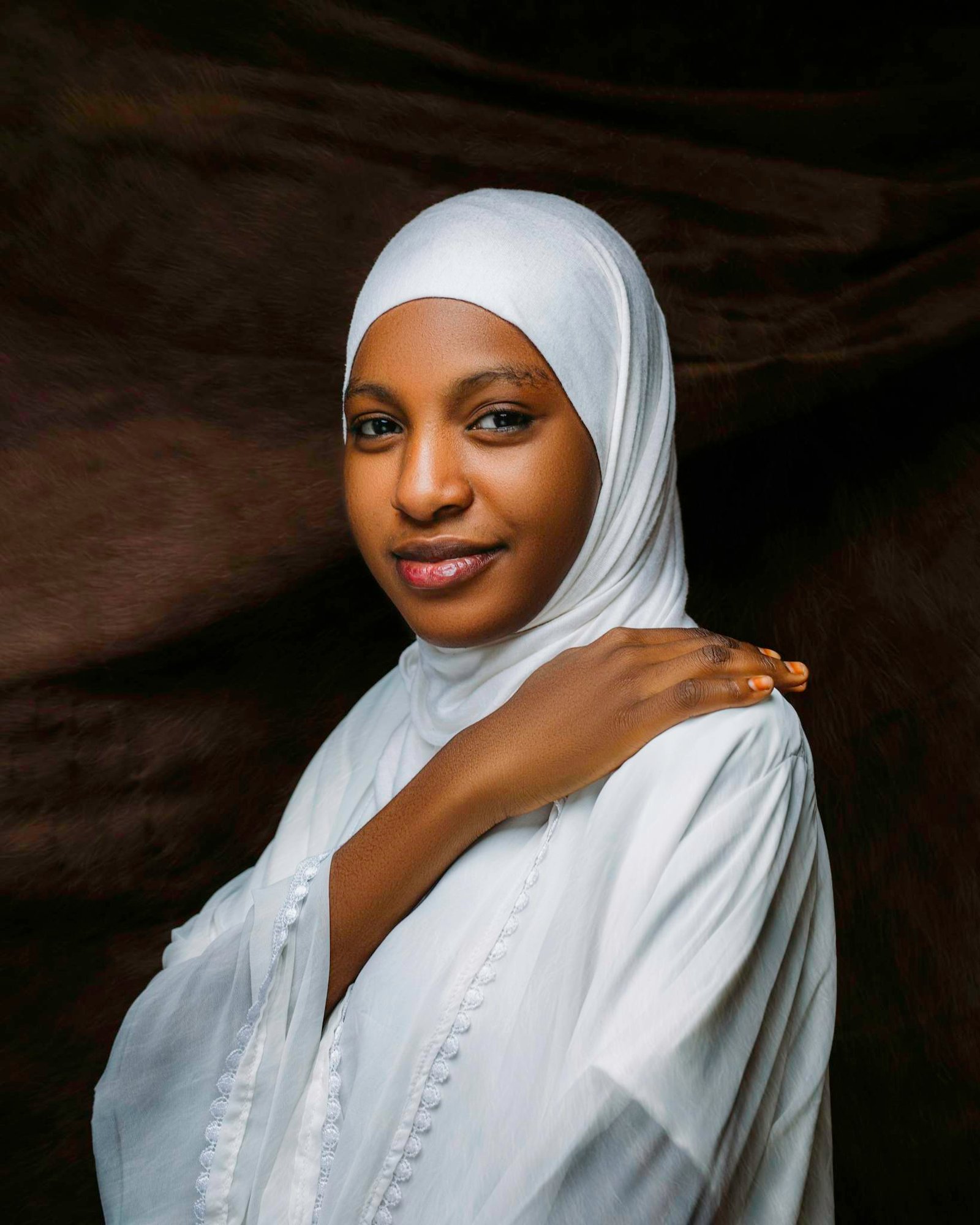 Graceful portrait of a woman wearing a white hijab, promoting cultural elegance and diversity.